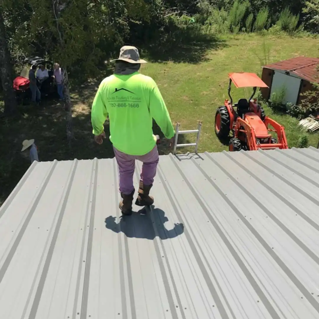 Commercial roofing contractor installing standing seam panels during a commercial metal roofing project by Achilles Roofing & Exterior