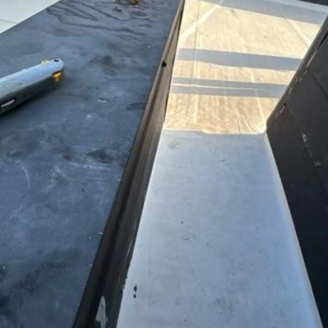 Commercial roof repair detailing around a parapet wall flashing by Achilles Roofing & Exterior