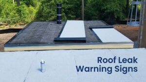 1. Roofing materials being rolled out for a quick roof leak repair on a flat commercial building.