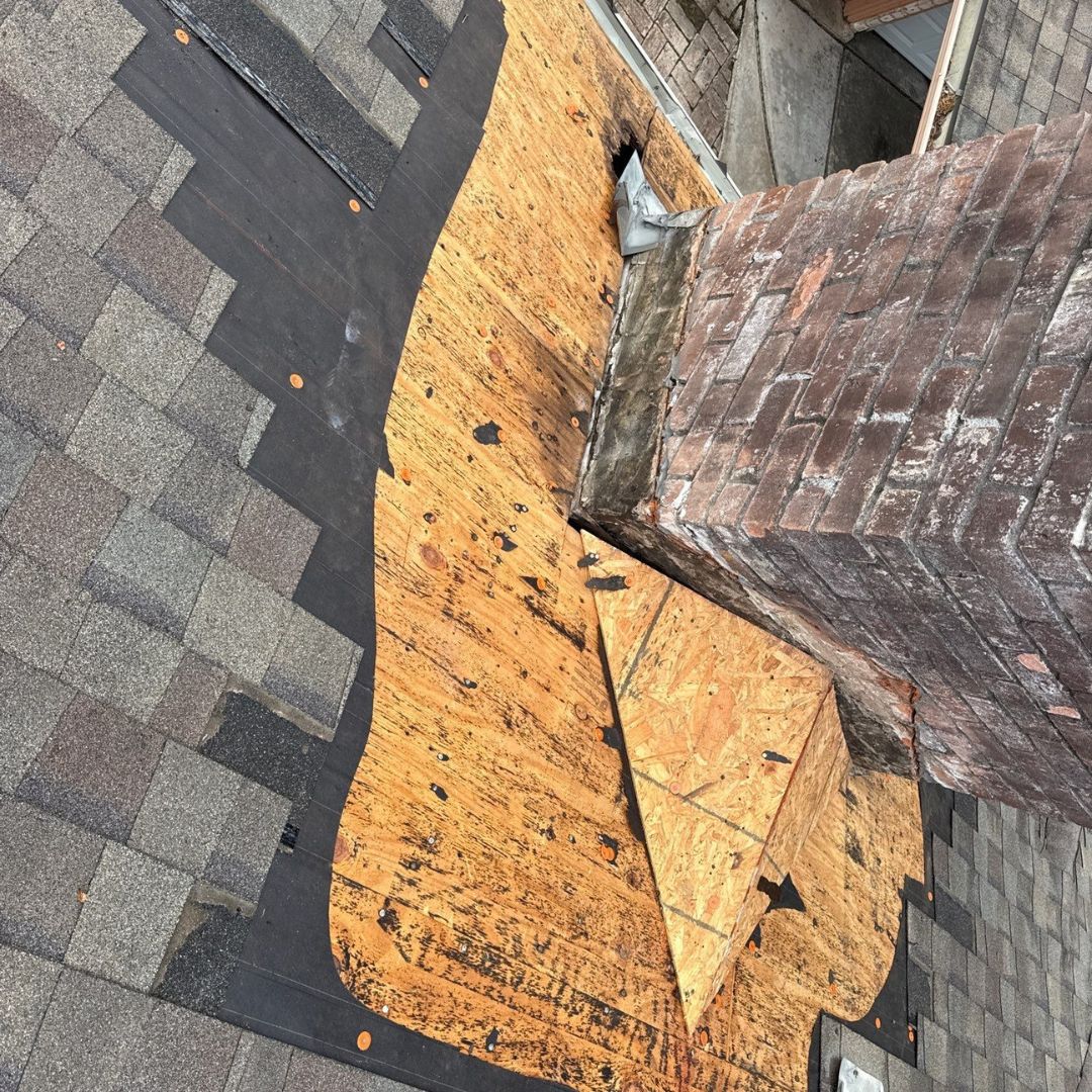 Water-damaged rotted plywood roof decking exposed during a roof repair project by Achilles Roofing & Exterior