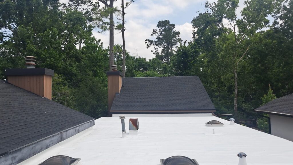 Quality roof repair in Houston featuring new shingles and a reflective flat roof for better durability and energy efficiency.
