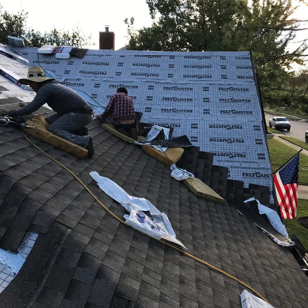Professional roofing crew carrying out steep-slope asphalt shingle repair by Achilles Roofing & Exterior