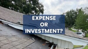 A ground-level photo focused on the eaves of a house, highlighting significant wear and tear. The asphalt shingles are visibly deteriorated, peeling, and missing, and the adjacent gutter is clogged with leaves. A blue overlay with white text poses the question: "EXPENSE OR INVESTMENT?", prompting users to consider a full roof installation or replacement.