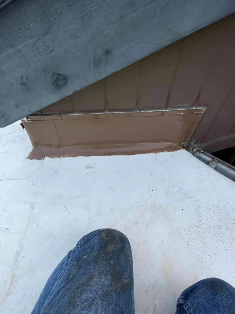 This image displays close-up of the flashing detail and membrane junction, illustrating a professional finish and readiness to withstand Houston weather.