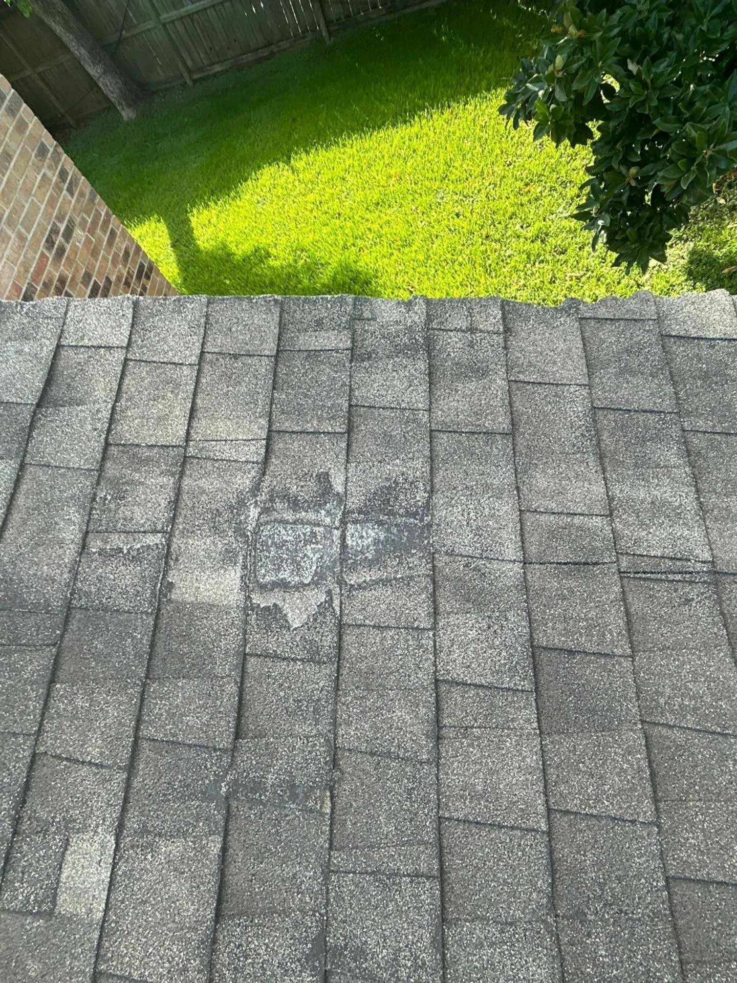 This image shows the roof before replacement, with worn and damaged shingles on a Houston, TX home — clearly highlighting the old roof’s age and deterioration.