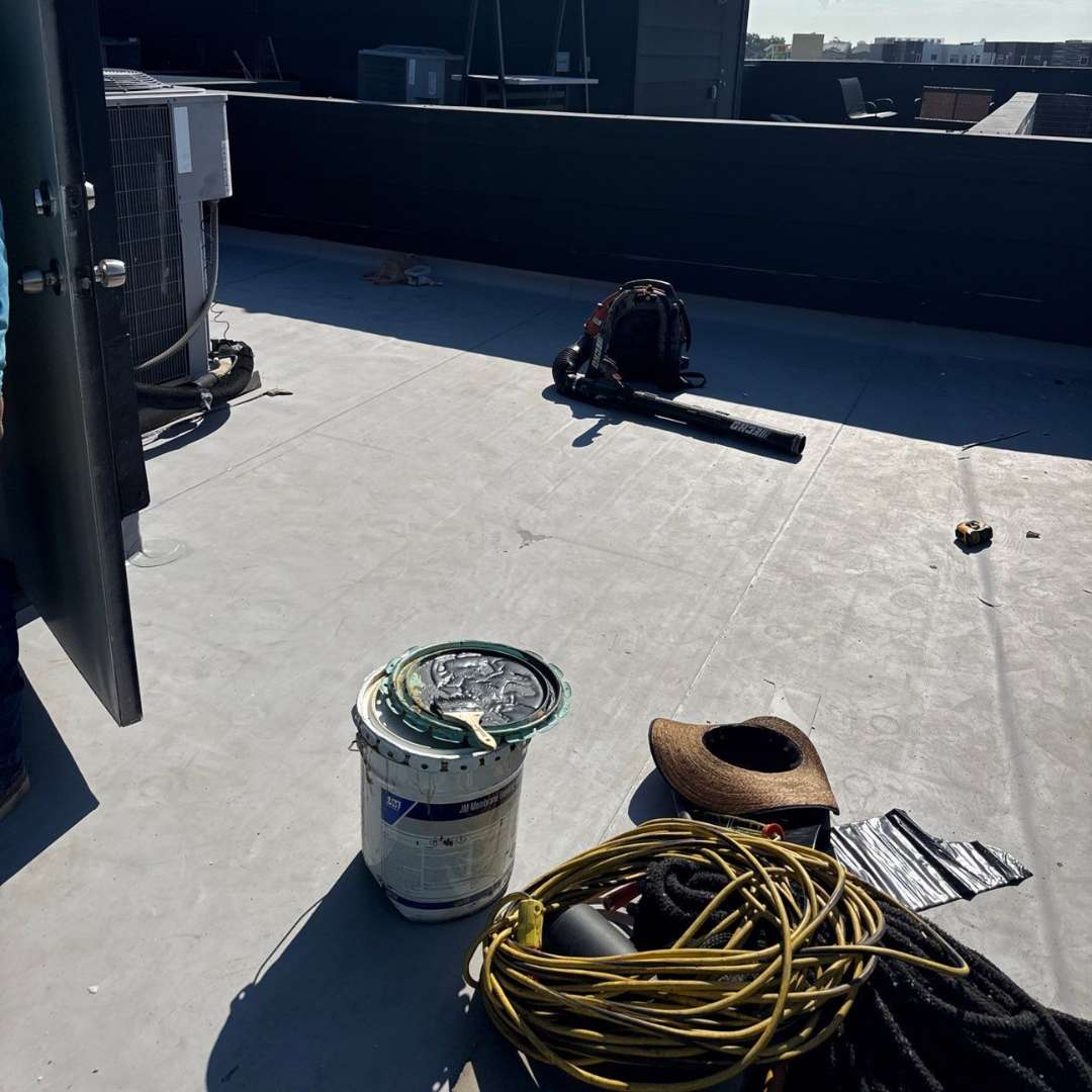 Commercial built up roofing materials and installation equipment on flat roof by Achilles Roofing & Exterior