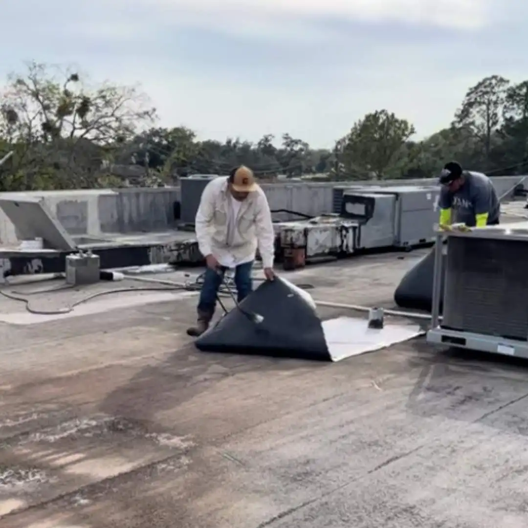 Commercial roofing contractors installing built up roofing around HVAC equipment by Achilles Roofing & Exterior