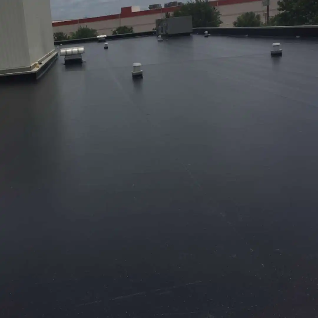 Large commercial built up roofing flat roof system with roof drains installed by Achilles Roofing & Exterior