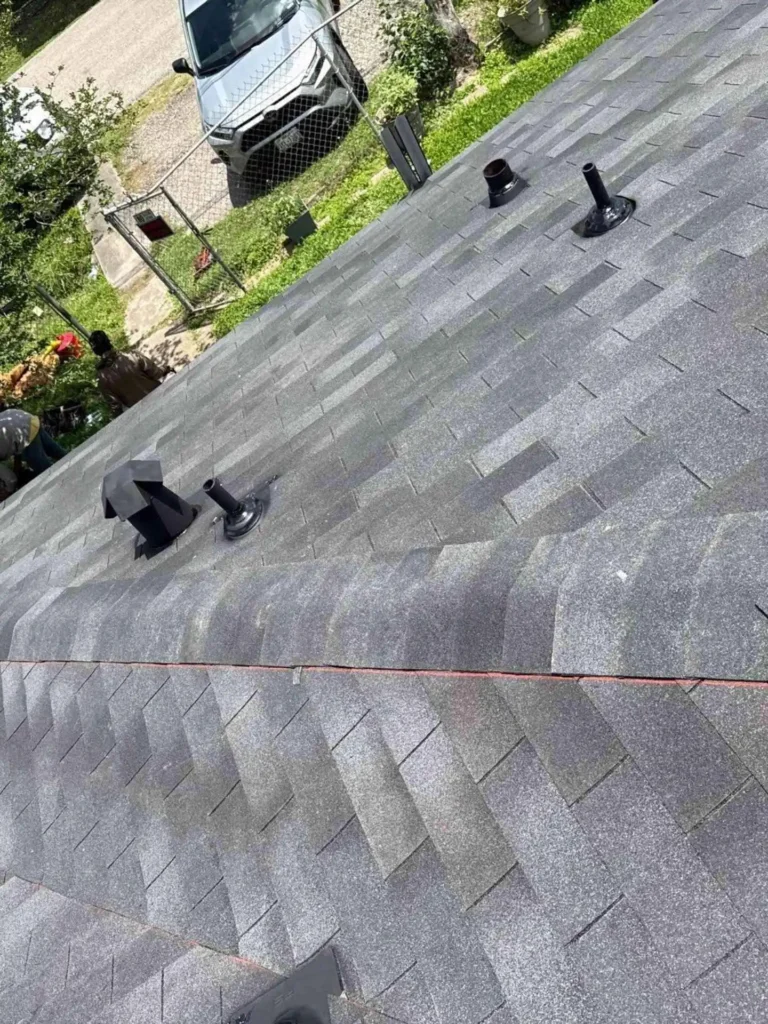 This image displays the completed roof replacement project on a Houston home, demonstrating the improved weatherproofing and renewed exterior look provided by the new shingles.