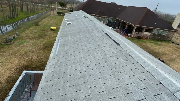 This image shows the newly repaired roof on a Baytown home — shingles have been replaced and the ridge appears uniform and secure, reflecting a professional roof repair job.