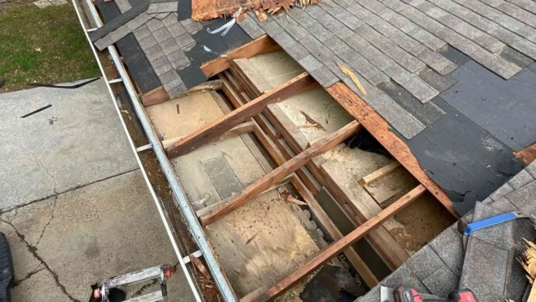 This image shows a Houston, TX roof with broken and missing shingles, and an exposed deck awaiting professional Roof Repair, highlighting the severity of weather-related damage.