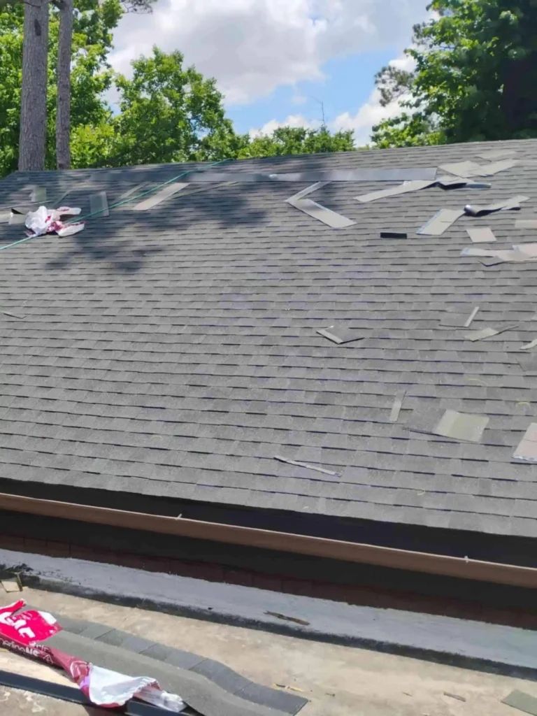 This picture shows multiple shingles displaced or deteriorated across the roof of a Houston home — highlighting the need for timely shingle repair to prevent leaks or further damage.