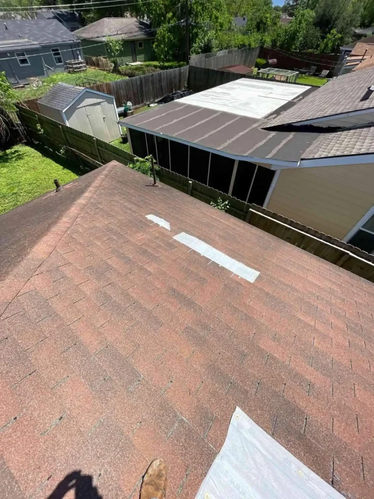 This image shows the installed emergency tarp stretched across a storm-compromised roof on a Houston, TX home — secured and weather-tight to prevent further interior water damage.