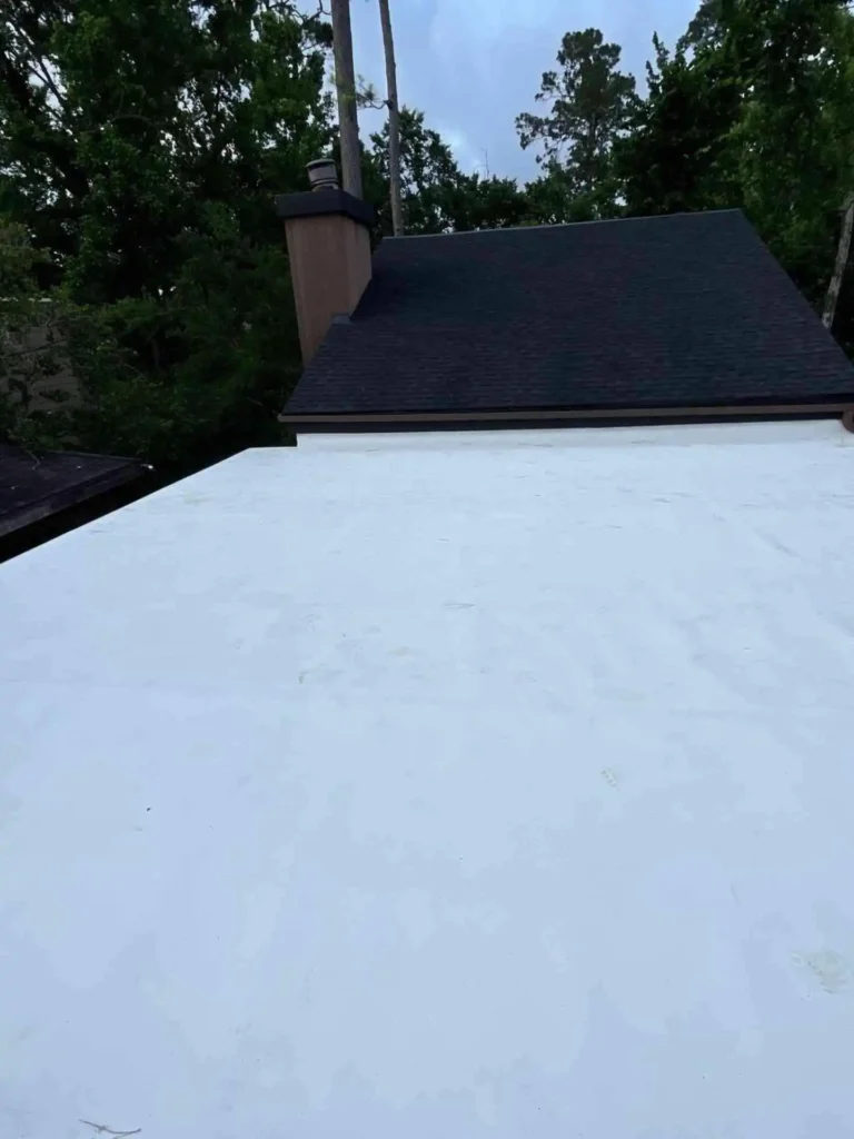 This image presents the completed flat roof retrofit from an angle, showing the uniform surface and professional workmanship under Houston’s sun.