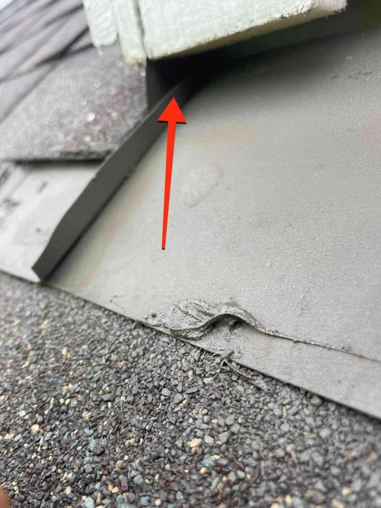 This image shows the original roof’s metal flashing with visible signs of wear and potential leakage before the full roof system tear-off & rebuild in Pearland, TX.