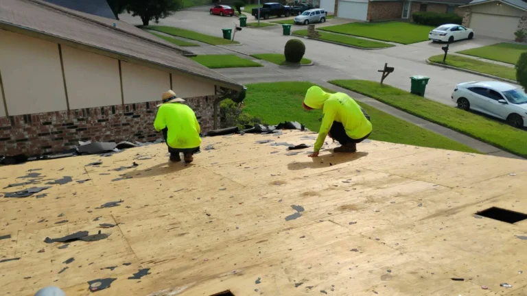 This image shows a roofer carefully removing old roofing materials — torn off shingles and debris — right before installing the new roof on a Houston home.