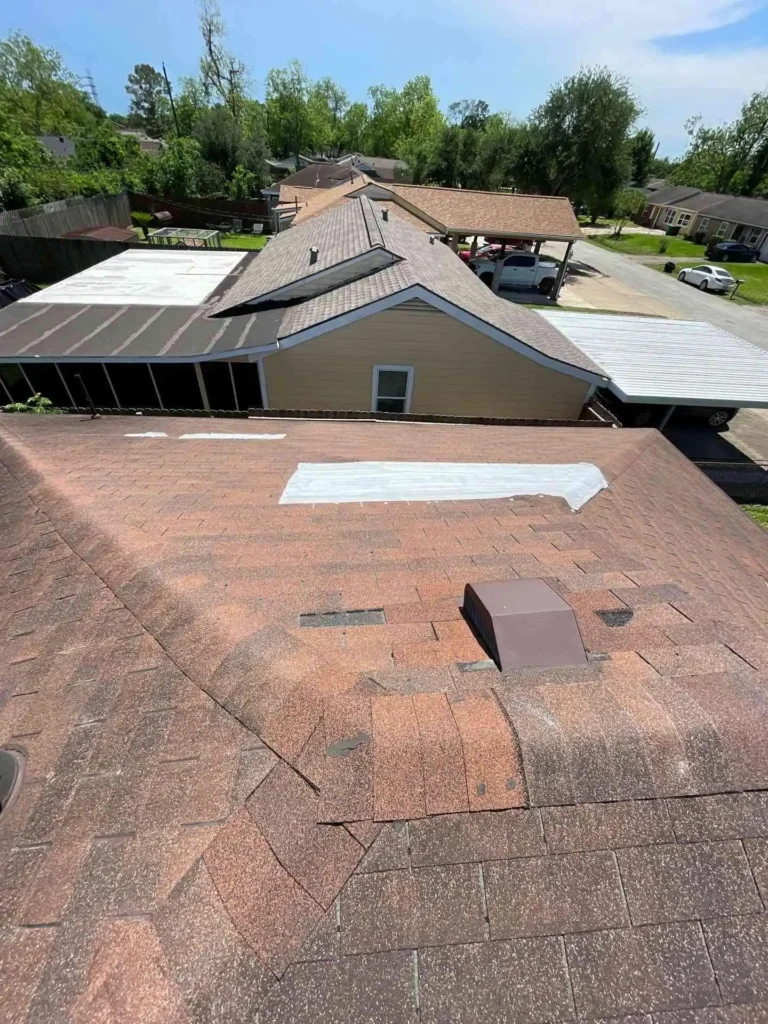 This image shows a professional Emergency Tarp Installation on a Houston, TX home after roof damage — the heavy-duty tarp is secured tightly over the affected area to prevent water intrusion.