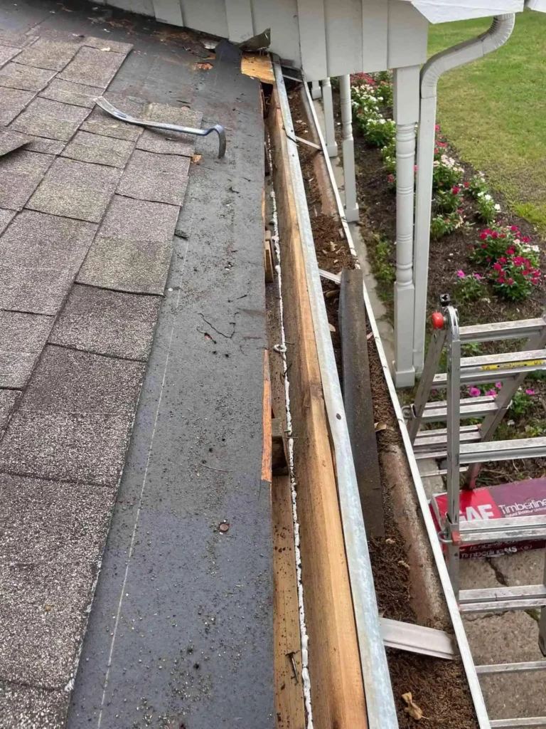 In this image, sections of the roof with absent shingles on a Houston home are visible, illustrating the damage that triggered the Roof Repair project.