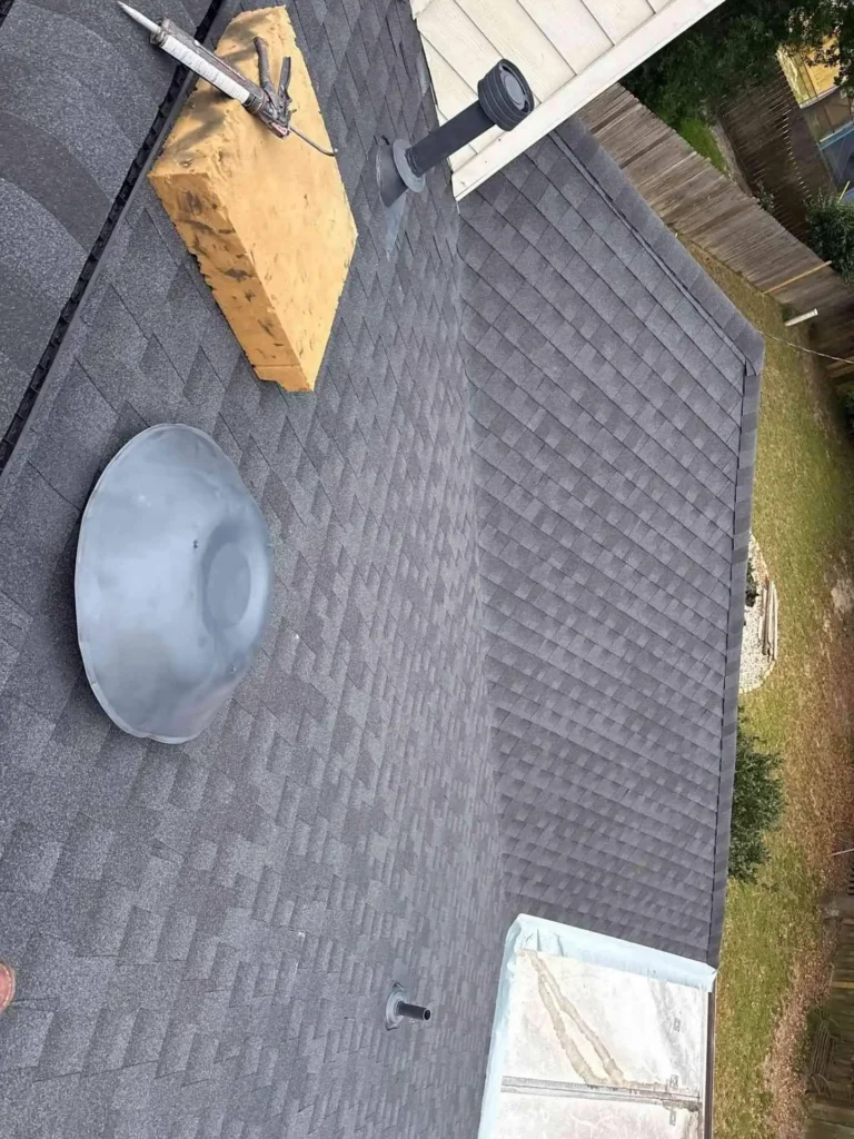 This image shows a Houston home with a newly installed roof after roof replacement, showcasing fresh shingles and clean roof lines.