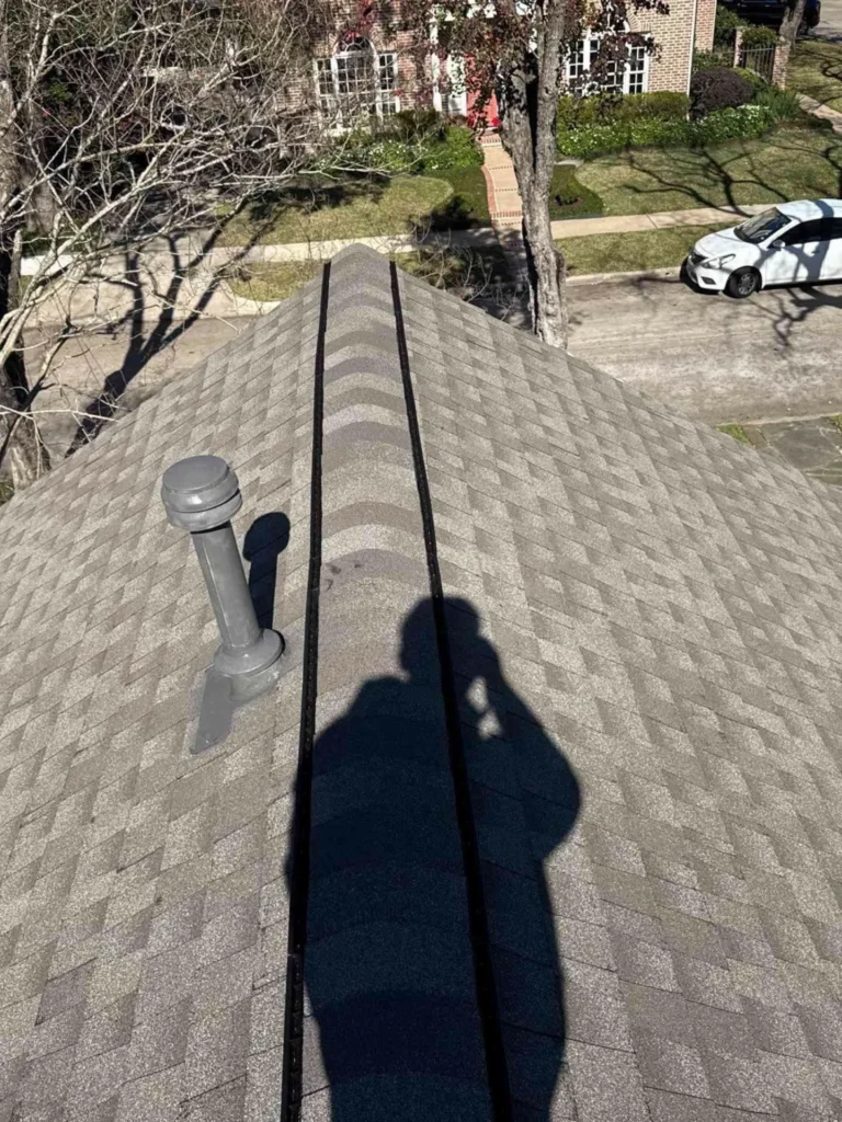 The photo highlights the newly installed shingles and updated ventilation vents, demonstrating the comprehensive restoration and improved airflow.