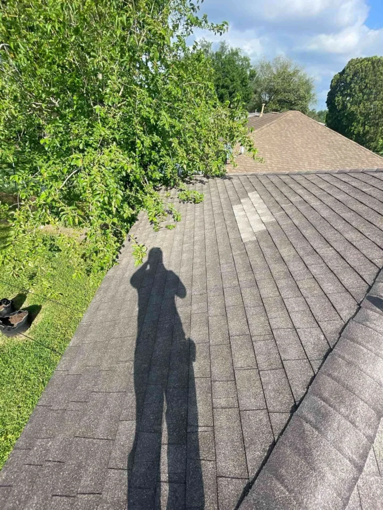 This image displays a partially stripped roof on a Houston property, showing the extent of shingle damage and the need for proper repair before re-roofing.