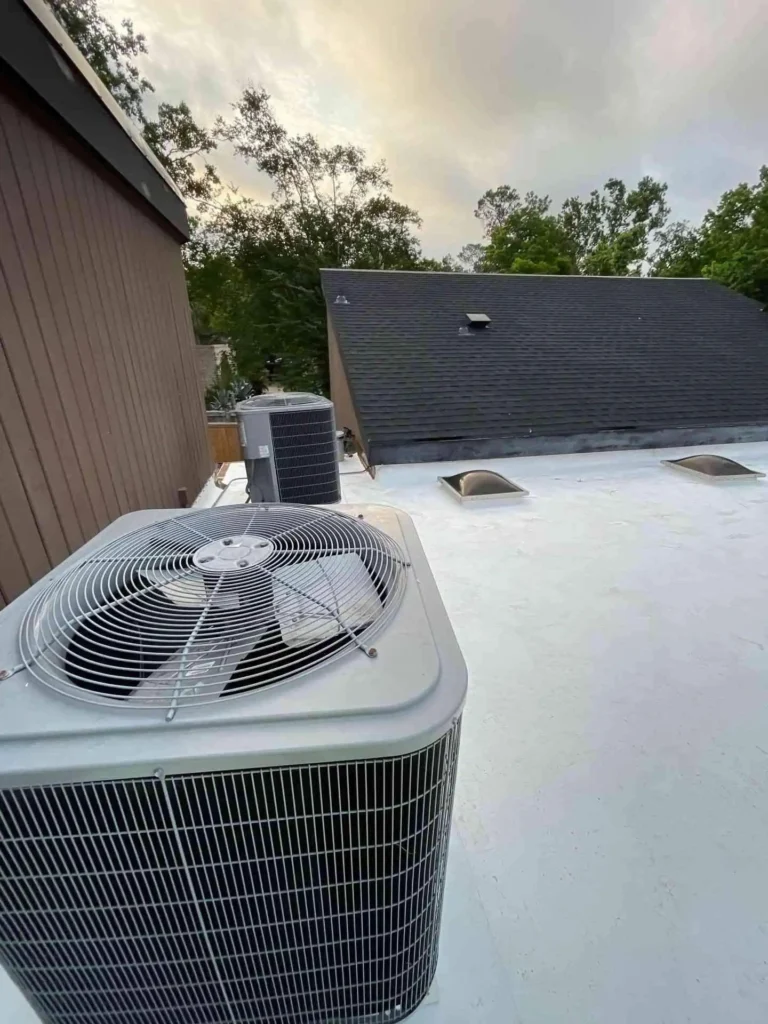 This image shows a rooftop after a flat roof retrofit in Houston, TX — new membrane laid cleanly over the existing roof deck, giving a sleek, waterproof surface.