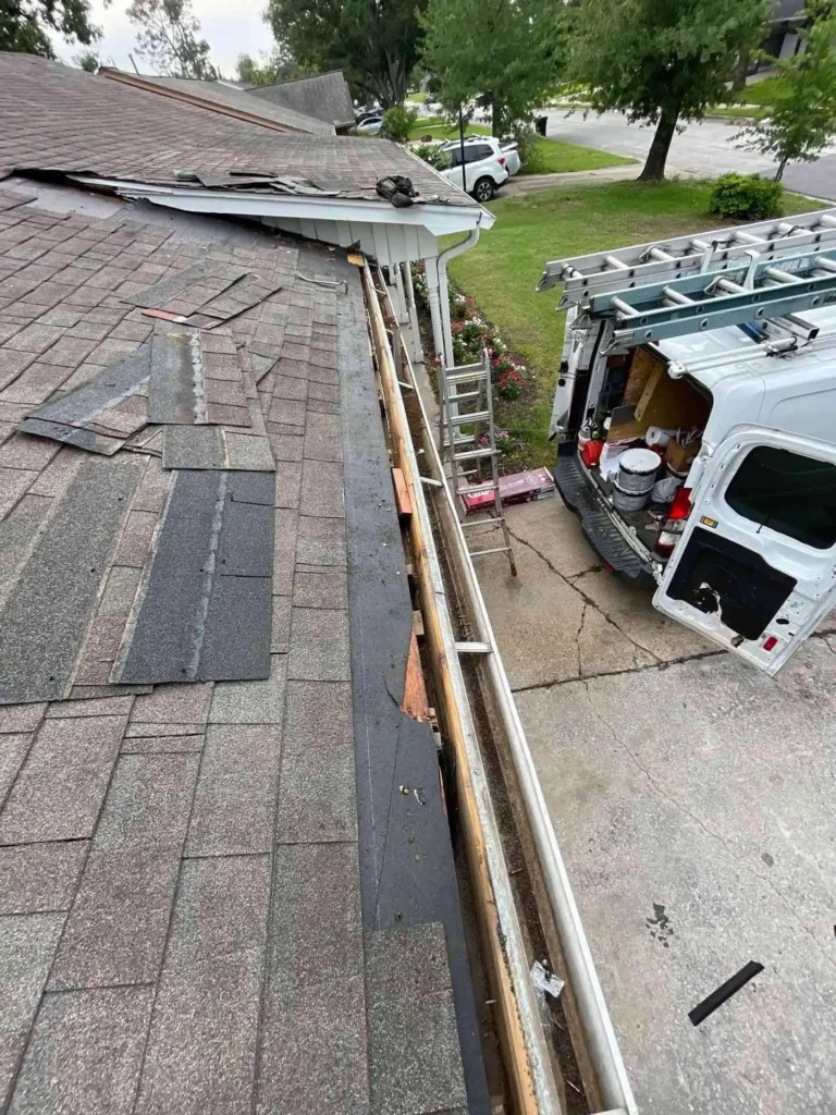 This picture captures the before-work state of a Houston roof with missing shingles and exposed decking, documenting why Roof Repair was necessary.