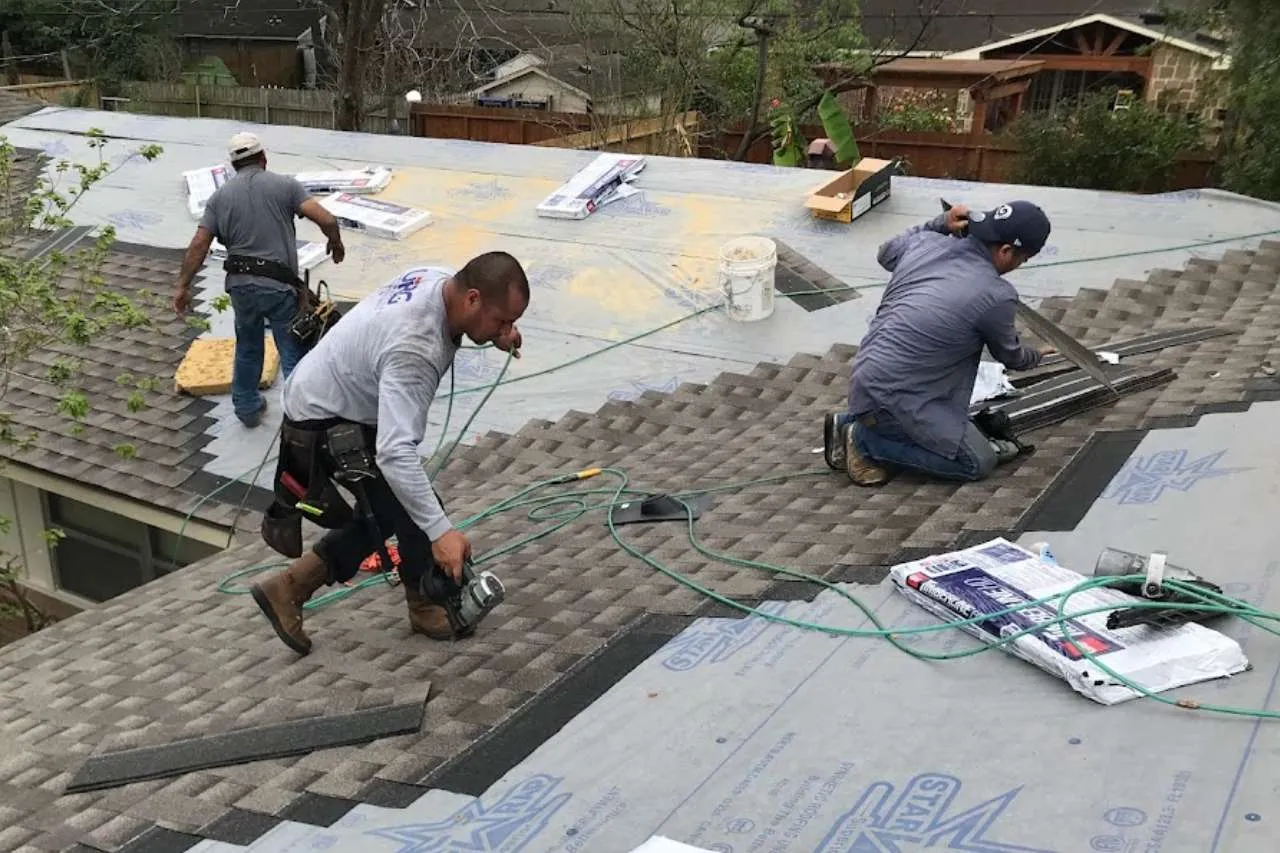 Achilles Roofing & Exterior crew installing architectural shingles during a professional roof replacement project in Houston.