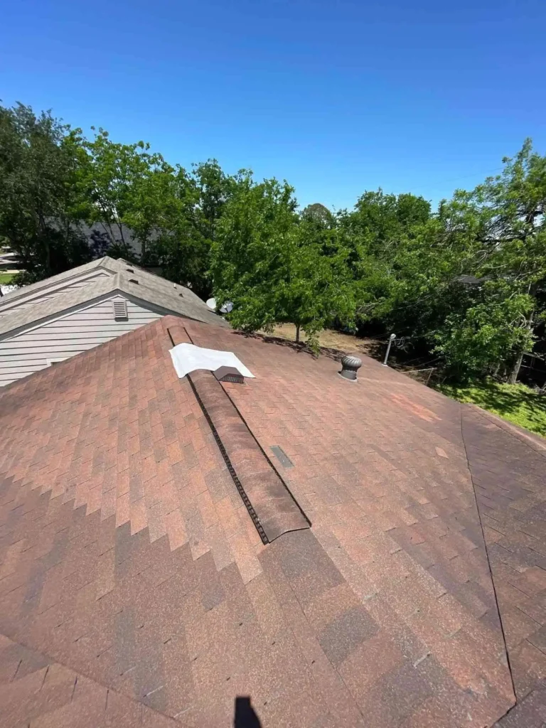 This image displays the temporary tarping in place after severe weather, showing how the Emergency Tarp Installation shields exposed roof sheathing in Houston, TX.