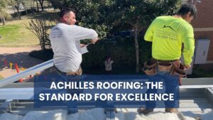 A high-quality image showing two crew members installing metal roofing materials. The overlay text, "ACHILLES ROOFING: THE STANDARD FOR EXCELLENCE", reinforces the company's commitment to delivering the best roof repair and installation services by emphasizing their professionalism, expert technique, and dedicated crew.