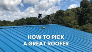 An image showing two professionals working on a completed or nearly completed blue metal roof. The text overlay, "HOW TO PICK A GREAT ROOFER", serves as a guide for customers searching for the best roof repair specialists, positioning the company as a trustworthy source of expert service and advice.
