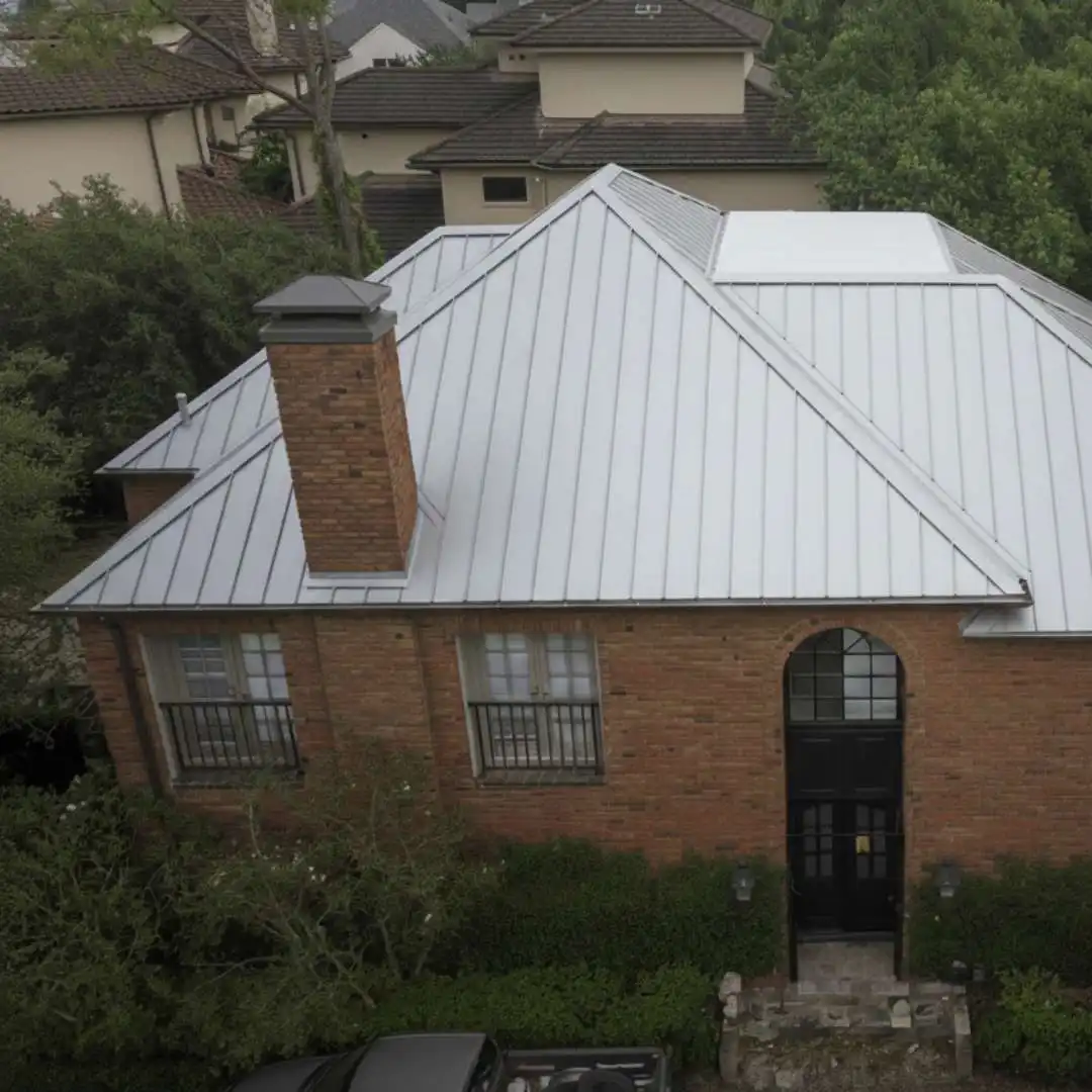 Two-story brick residential home with corrugated metal roofing installed by Achilles Roofing & Exterior