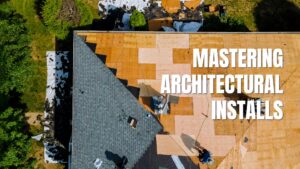 How to Install Architectural Shingles. Close-up of a finished dark grey shingle roof highlighting the layered texture and complex hip and valley joints.