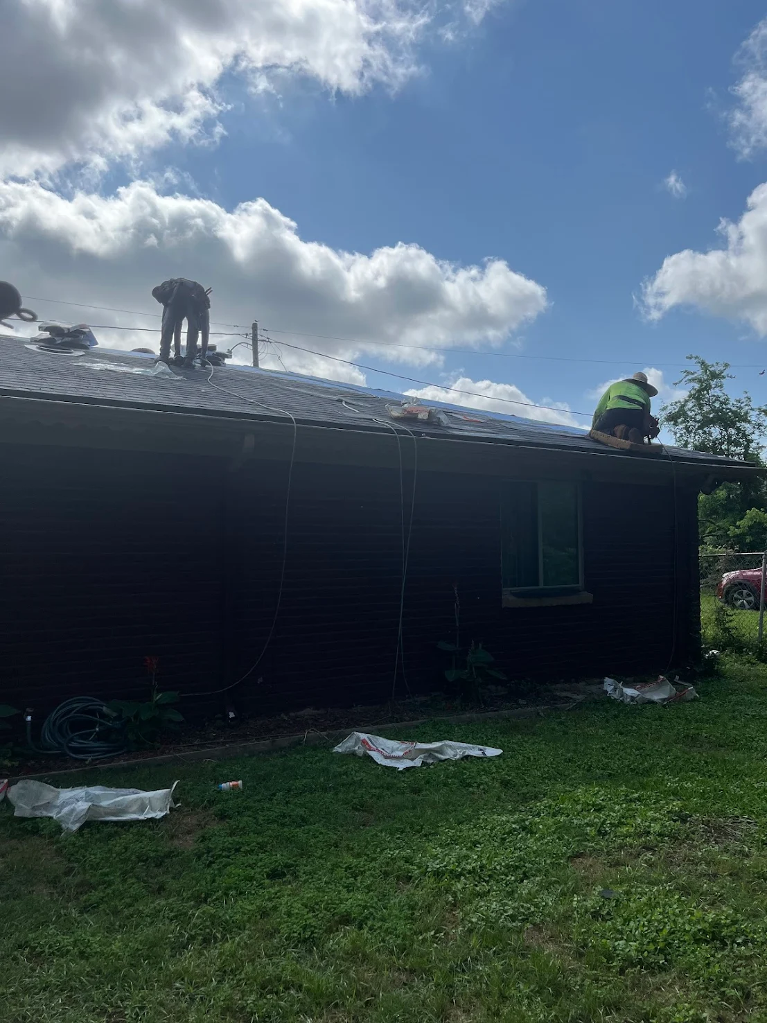 Achilles Roofing Houston crew performing an early morning roof tear-off for a residential replacement.