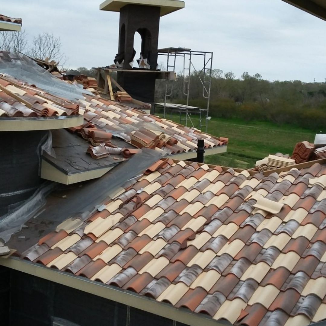 Spanish tile installation on a residential roof deck by Achilles Roofing & Exterior