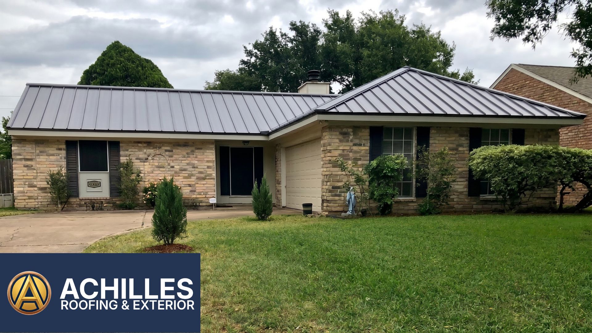 An aerial perspective of a sprawling multi-gabled home featuring a brand-new dark charcoal aluminum metal roof installation by Achilles Roofing & Exterior.