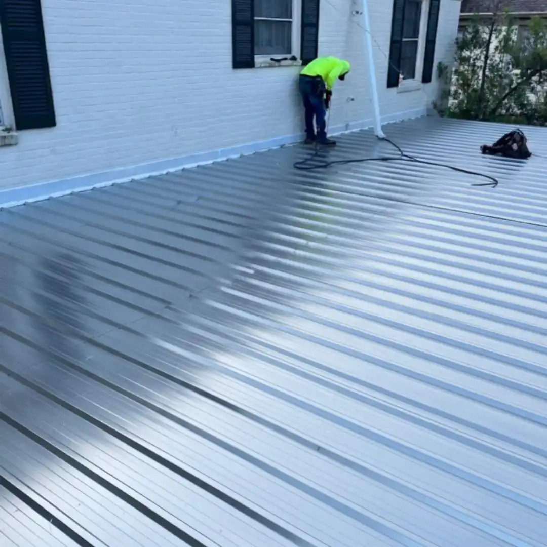 Roofing contractor installing and inspecting a residential metal roof retrofit by Achilles Roofing & Exterior