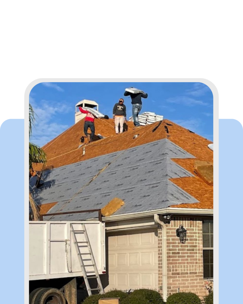 Roofing crew removing old shingles and installing a new residential roof system.