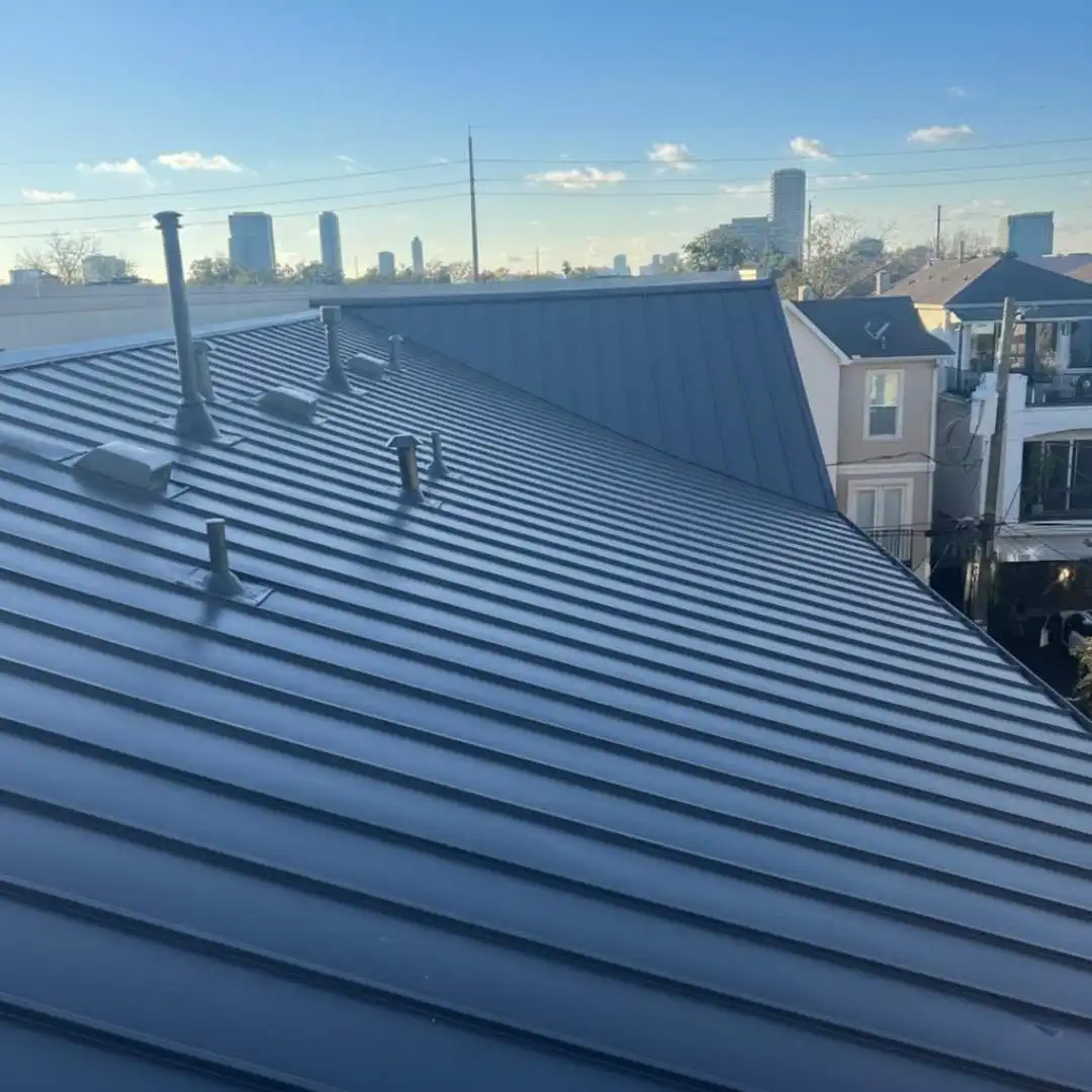 Blue standing seam metal roof installed on a residential home as part of a premium roofing system by Achilles Roofing & Exterior