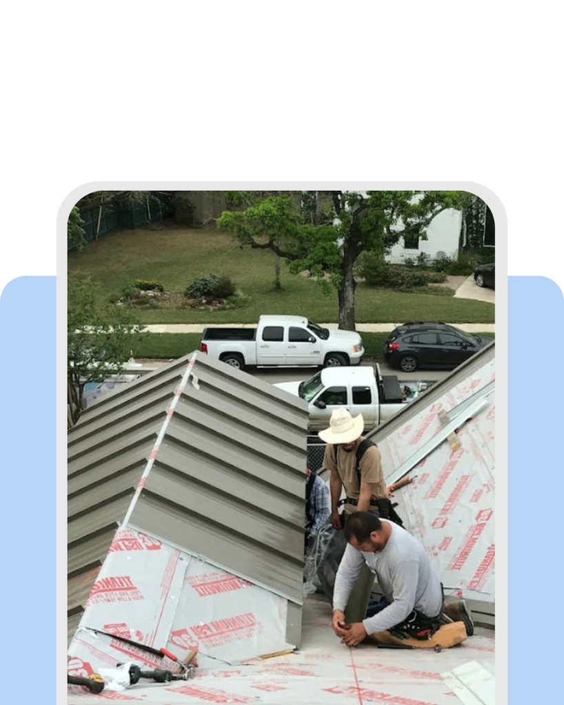 Professional roofer installing new roofing tiles on a residential home.